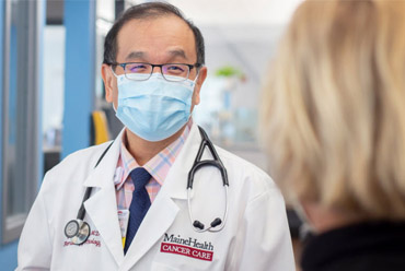 Asian American Doctor Talking to a Patient